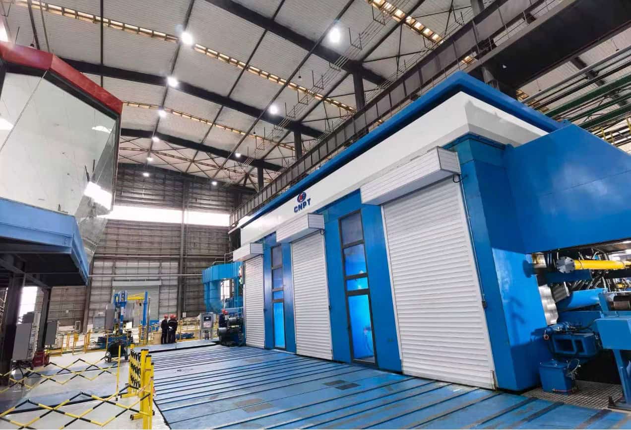 Modern industrial manufacturing facility with advanced machinery in a spacious warehouse.